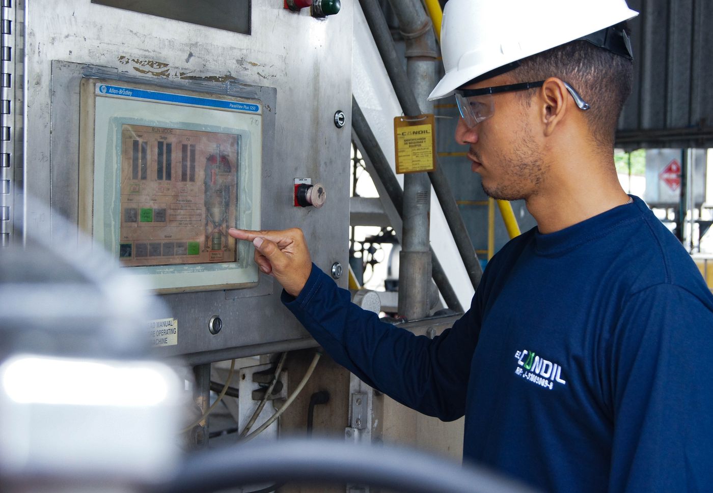 Controls technician using a PLC touchscreen panel